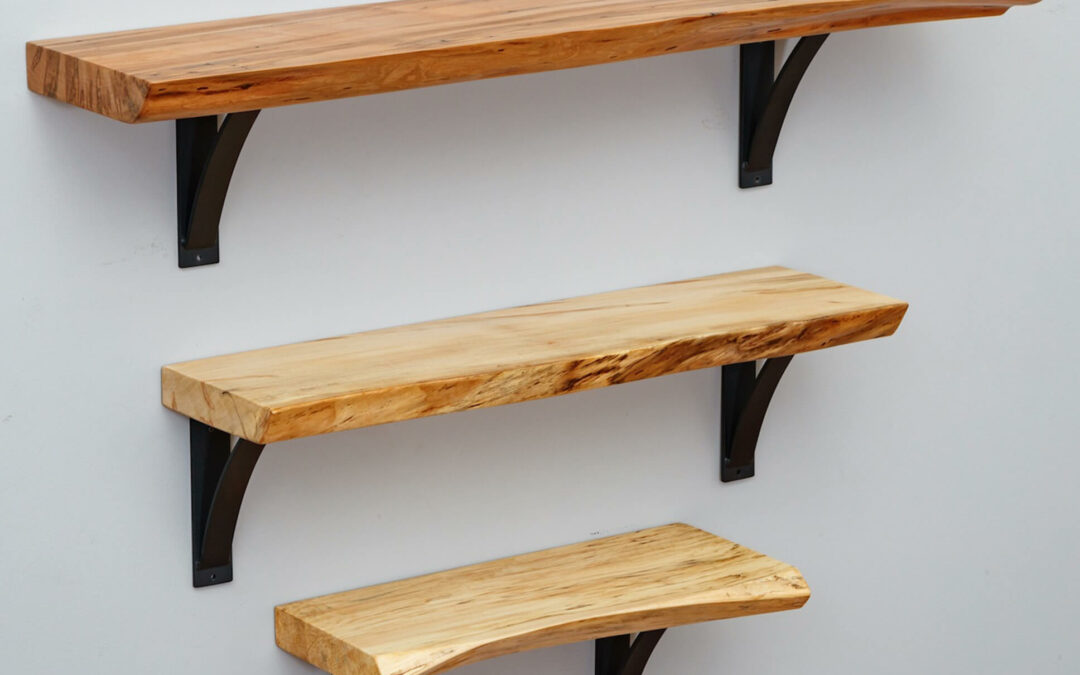 Morris Hill Metal Craft Quarryville, PA Three handcrafted live edge wooden shelves hanging on a wall.