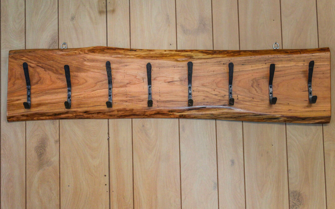 Morris Hill Metal Craft Quarryville, PA A live edge wooden coat rack with hooks hanging on it.
