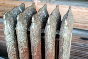 A group of old radiators on a wooden floor.