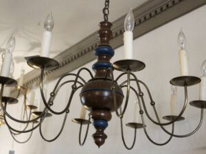 A chandelier with a lot of electric candles hanging from it.