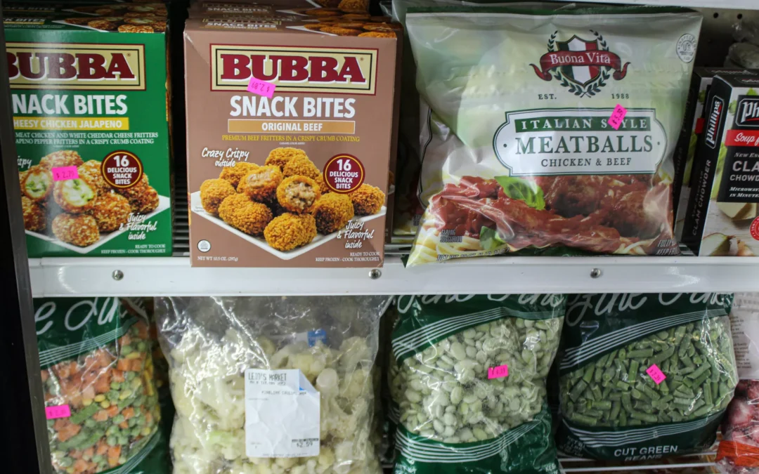 2.27.21-Leids-Market-Gallery-1-3-scaled-1 Boxes of Bubba Snack Bites and a bag of Buona Vita meatballs are displayed on a shelf above bags of frozen vegetables in a freezer.