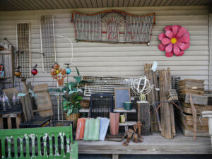 A front porch with a lot antique items on it.
