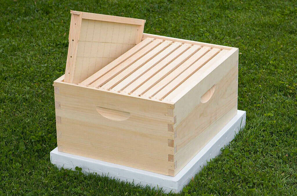 Forest Hill Woodworking Paradise PA A wooden bee hive box sitting on the grass.