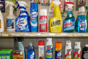 A row of cleaning products on a shelf in a hardware store.