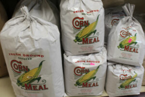 A bag of corn meal sits on a shelf.
