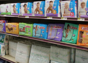 A shelf full of diapers in a store.