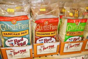 A bag of gluten free brownie, pizza crust, and pancake mix.