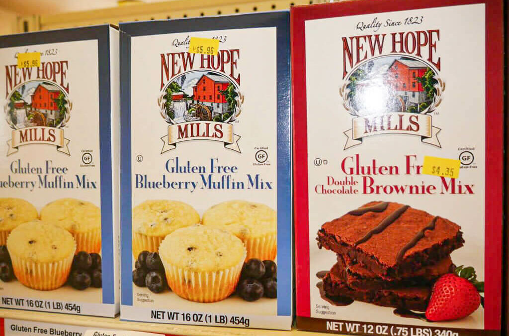 Willow Creek Discount Grocery Reinholds, Denver PA A box of New Hope Mills gluten free brownie mix and blueberry muffin mix sits on a shelf.