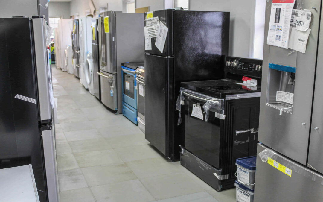 Slate Road Supply Ephrata PA A variety of new refrigerators and stoves lined up for sale in an appliance store.