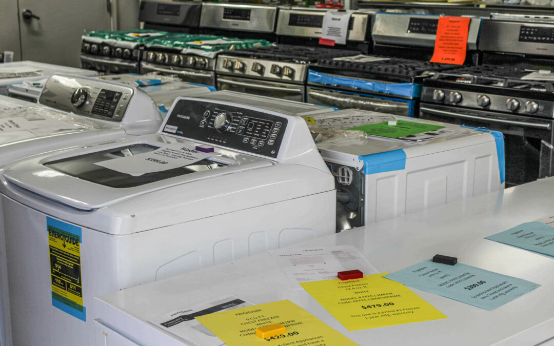 Slate Road Supply Ephrata PA A variety of washing machines on display in an appliance store, showcasing different models and price tags on them.