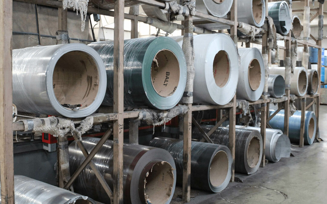 Slate Road Supply Ephrata PA Large rolls of metal sheeting stored on racks in an industrial warehouse.