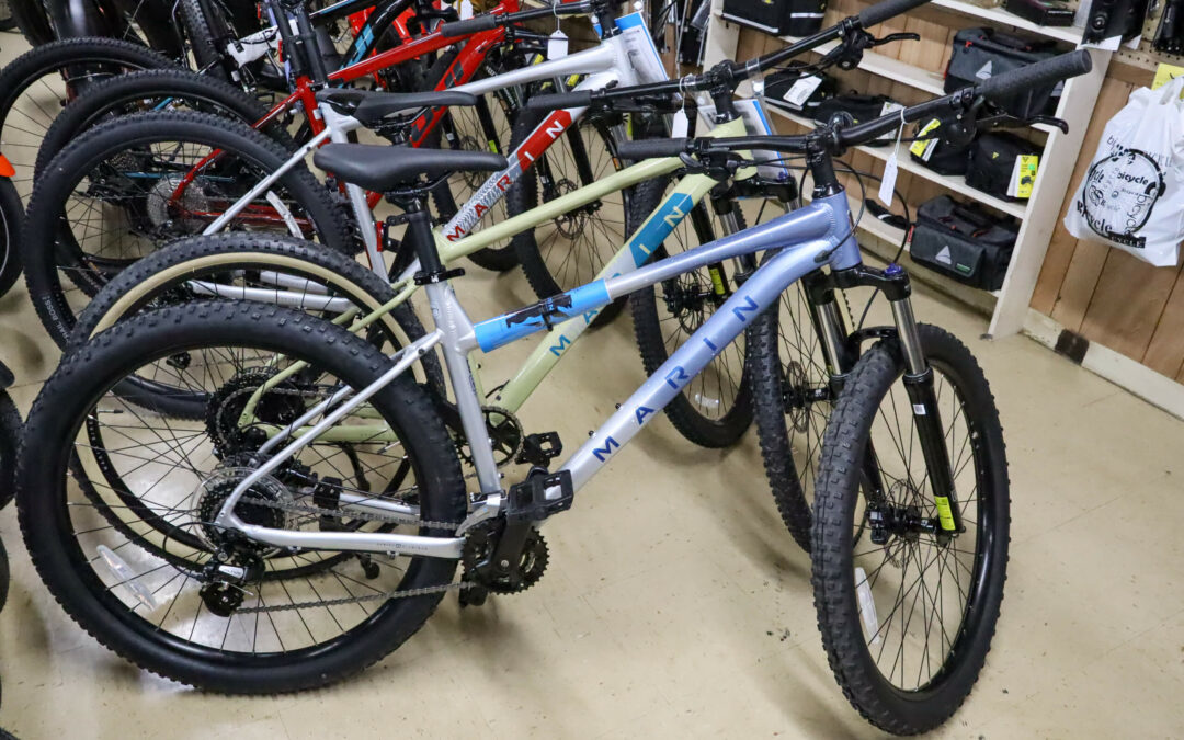 Weaver's Bike Shop Ephrata PA Several mountain bikes with different colored frames are lined up on display in a store. The bikes have "MARIN" written on the frames.