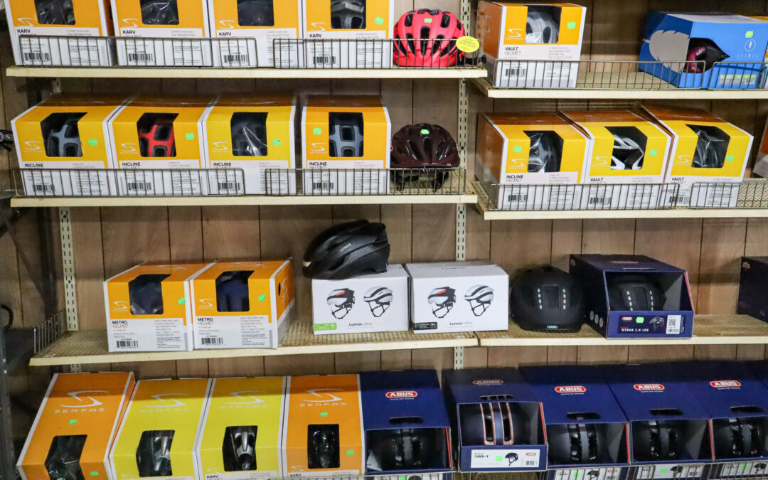Weaver's Bike Shop Ephrata PA Shelves display various bicycle helmet brands and models in boxes, with different colors and designs, at a store.