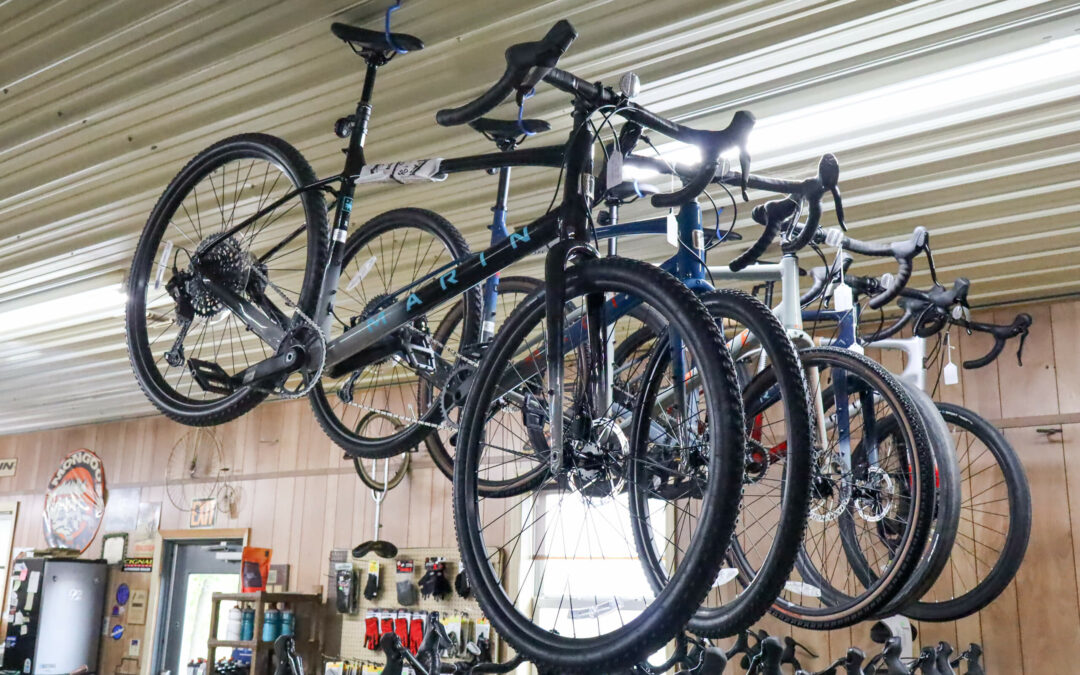 Weaver's Bike Shop Ephrata PA Several bicycles are suspended from the ceiling in a bike shop with a wooden interior. Accessories and tools are visible in the background.