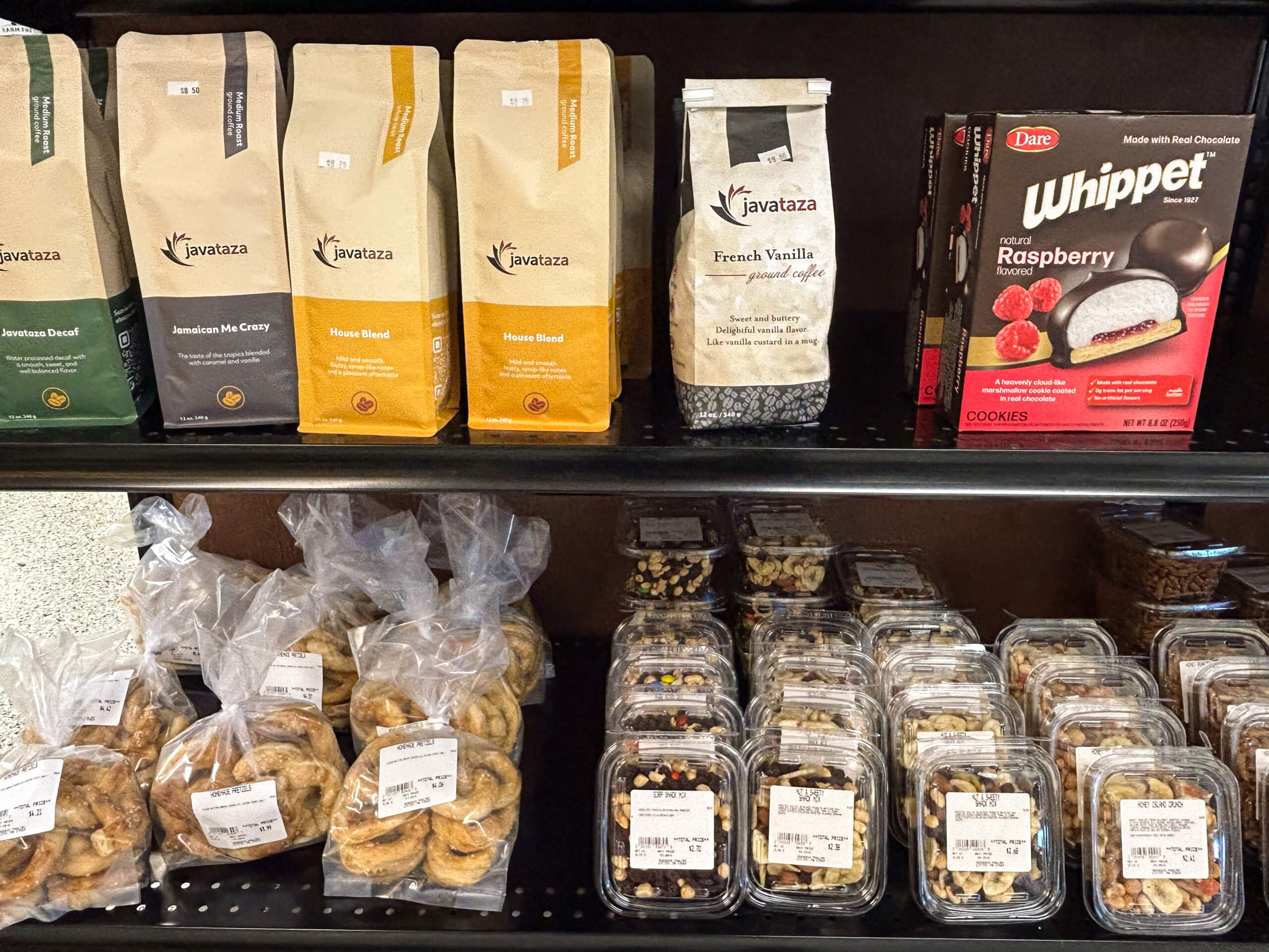Sensenig Poultry Lititz PA Shelves display bags of Javatza coffee, a box of Whippet raspberry cookies, and various packaged baked goods and mixed nuts.
