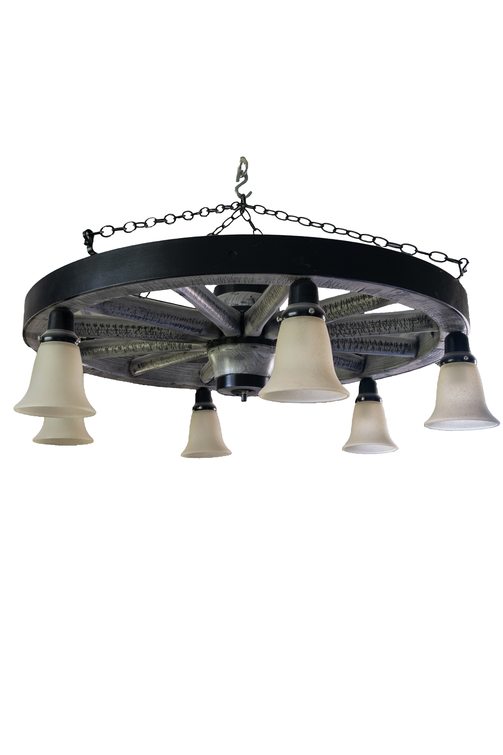 7.8.26 Spring Valley Woodworking Light Fixtures Gallery 4 A metal chandelier designed like a wagon wheel, with six downward-facing frosted glass light shades, suspended by chains.