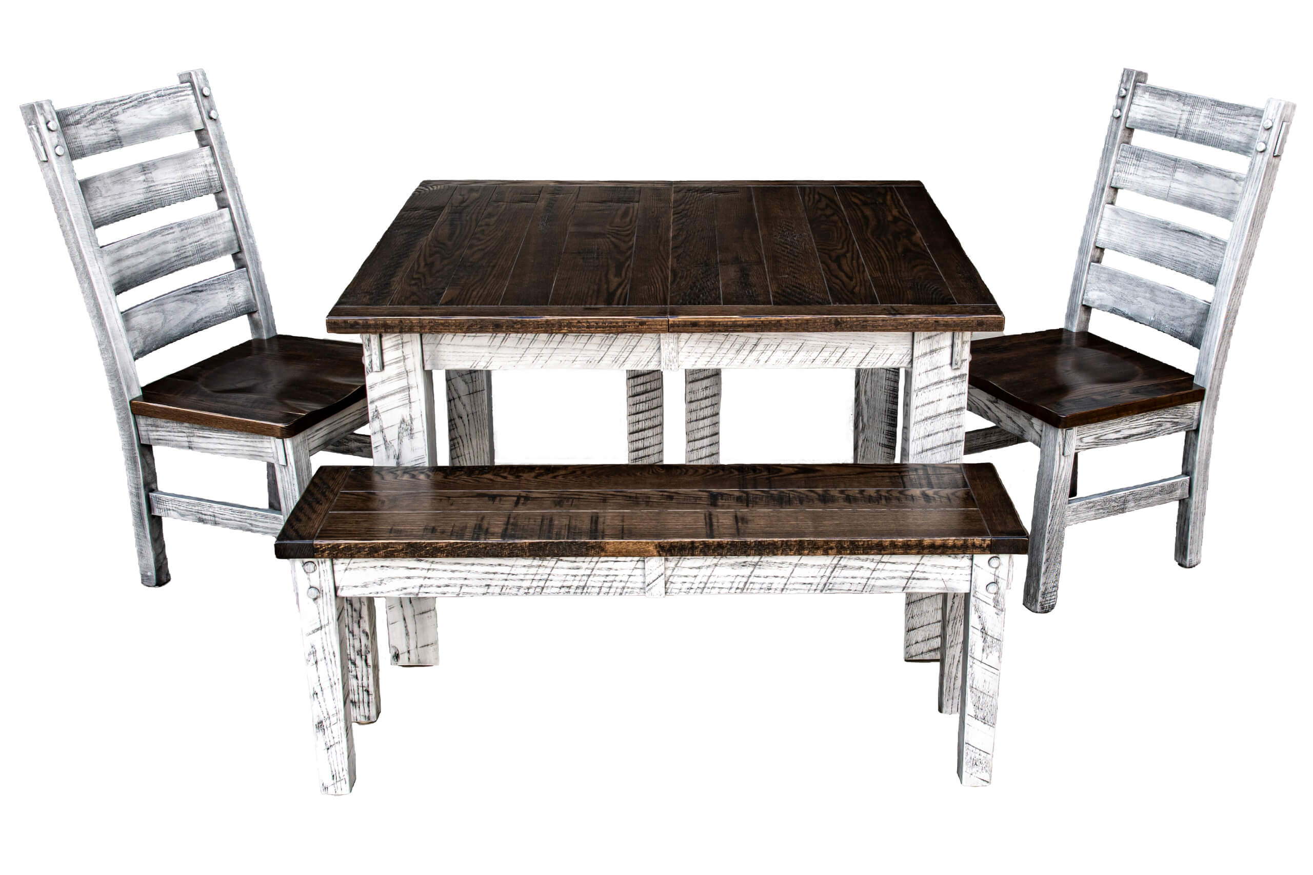 7.8.26 Spring Valley Woodworking Tables Gallery 10 A rustic wooden dining set with a square table, two chairs, and a bench. The set has a dark brown surface and distressed white legs and frames.