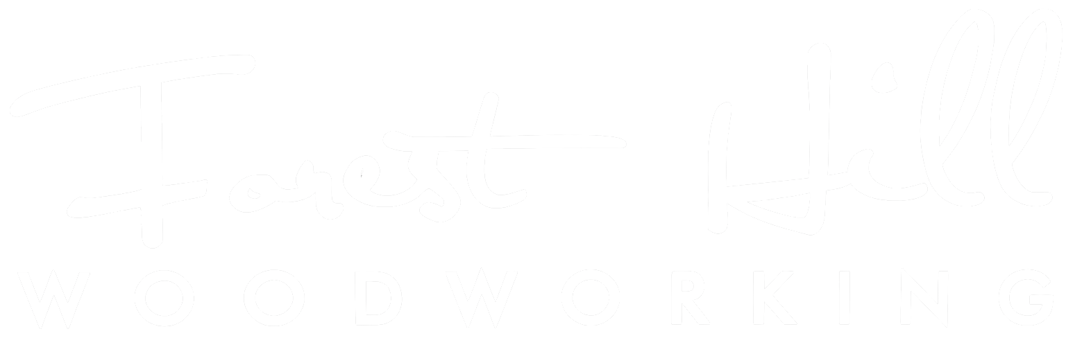 Forest Hill Woodworking“ written in large, white cursive and block letters on a light gray background.