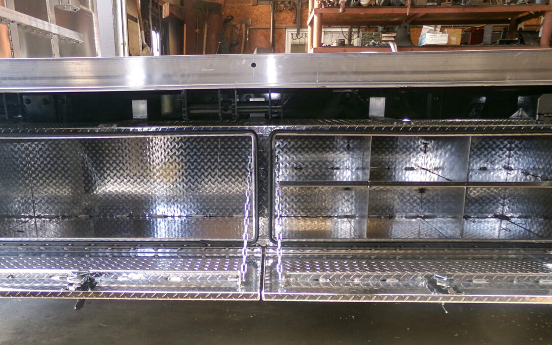 9.9.26 Nickel Mine Welding Gallery 1-2 Open metal storage compartments with diamond plate pattern inside an industrial workshop setting.