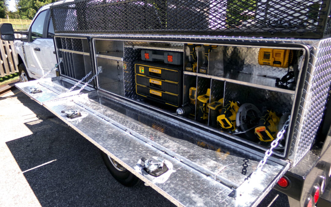 9.9.26 Nickel Mine Welding Gallery 2-6 Open side compartment of a work truck displaying organized power tools, toolboxes, and equipment in metal storage shelves.